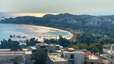 a view of a beach from a building at Vouliagmeni Bay Stylish house with private garden in Athens