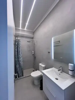 a bathroom with a sink and a toilet and a shower at Acropolis Open Sky Family by Zeus Suites in Athens