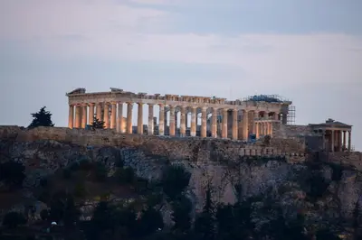 a building sitting on top of a mountain at Acropolis Open Sky Family by Zeus Suites in Athens