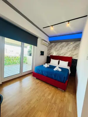 a bedroom with a bed and a large window at Acropolis Open Sky Family by Zeus Suites in Athens