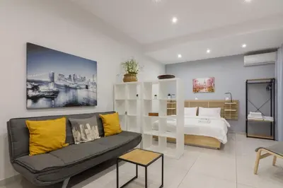 a living room with a couch and a bed at A little gem in the heart of Athens in Athens