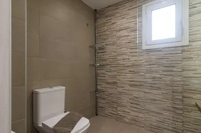 a bathroom with a toilet and a window at A little gem in the heart of Athens in Athens