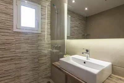 a bathroom with a white sink and a mirror at A little gem in the heart of Athens in Athens