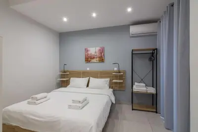 a bedroom with a large white bed with towels on it at A little gem in the heart of Athens in Athens