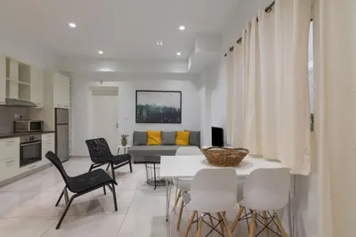 a living room with a table and chairs and a couch at Heaven apartment in the heart of Athens in Athens
