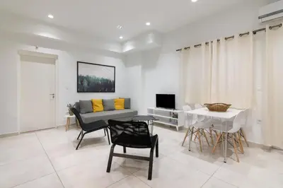 a living room with a couch and a table at Heaven apartment in the heart of Athens in Athens