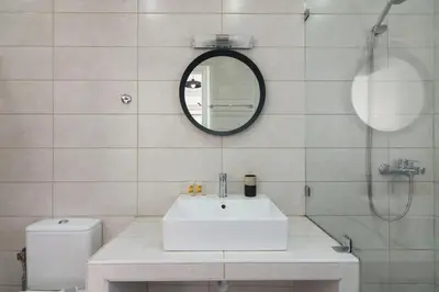 a bathroom with a sink and a mirror and a toilet at Sunny paradise in the heart of Athens in Athens
