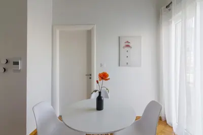 a white dining room with a white table and chairs at Sunny paradise in the heart of Athens in Athens