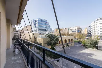 a balcony with a view of a city with buildings at Sunny paradise in the heart of Athens in Athens