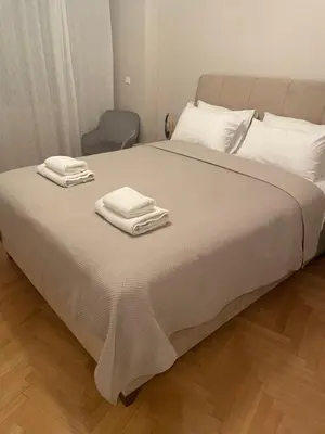 a bed with two towels on top of it at Adrianos Gate View Apartment in Athens