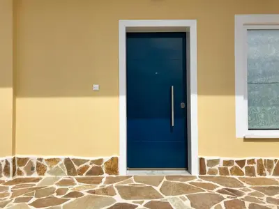 a blue door on the side of a house at Casa Arsida in Anavissos