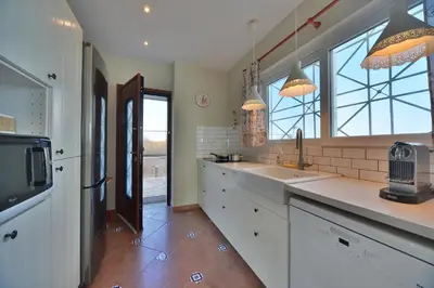 a large kitchen with a sink and a refrigerator at Casa Arsida in Anavissos