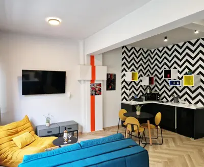 a living room with a couch and a table at Athens Central Suites Retreat in Athens