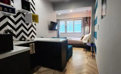 a kitchen with a sink and a room with a bed at Athens Central Suites Retreat in Athens