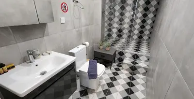 a bathroom with a white toilet and a sink at Athens Central Suites Retreat in Athens