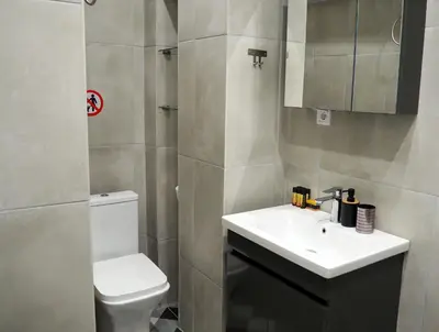 a small bathroom with a sink and a toilet at Athens Central Suites Retreat in Athens