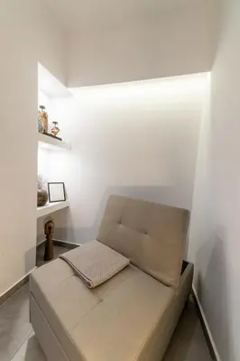 a couch in a room with white walls at Athenian Kolonaki Apartment in Athens