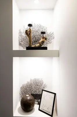 a shelf with two statues of cats on it at Athenian Kolonaki Apartment in Athens