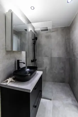 a bathroom with a black sink and a mirror at Athenian Kolonaki Apartment in Athens