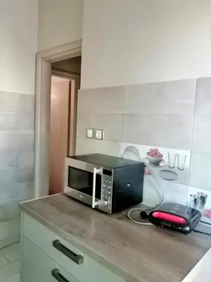 a microwave sitting on top of a counter in a kitchen at Raffaella Athens in Athens