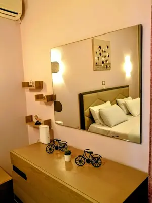 a bedroom with a bed and a large mirror at Raffaella Athens in Athens
