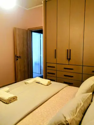 a bedroom with a bed with two towels on it at Raffaella Athens in Athens