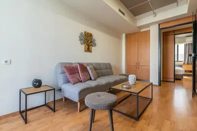 a living room with a couch and two tables at Kifisias View Apartment 1 in Athens