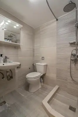 a bathroom with a toilet and a sink and a shower at Kifisias View Apartment 1 in Athens