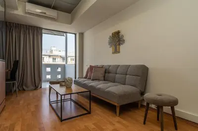 a living room with a couch and a table at Kifisias View Apartment 1 in Athens