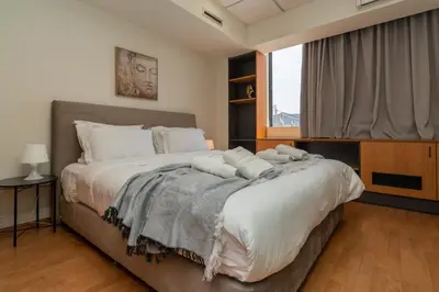 a bedroom with a large bed with white pillows at Kifisias View Apartment 1 in Athens