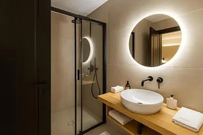 a bathroom with a sink and a shower with a mirror at Triple A - Psiri Urban Charm Studios at Theatrou Square I Free Parking in Athens