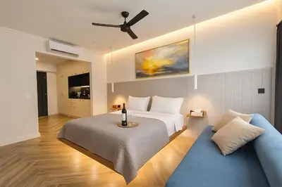 a bedroom with a bed and a blue couch at Triple A - Psiri Urban Charm Studios at Theatrou Square I Free Parking in Athens