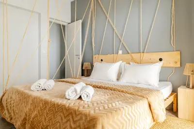 a bedroom with a bed with towels on it at Eclipse Vouliagmeni Center in Athens