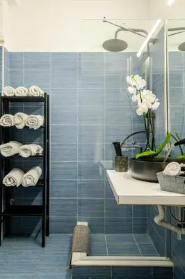 a bathroom with blue tiled walls and a sink at Eclipse Vouliagmeni Center in Athens