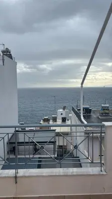 a view of the ocean from the deck of a ship at Spacious & Modern seaside house in Piraeus