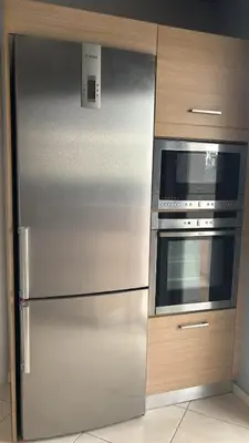 a stainless steel refrigerator and oven in a kitchen at Spacious & Modern seaside house in Piraeus