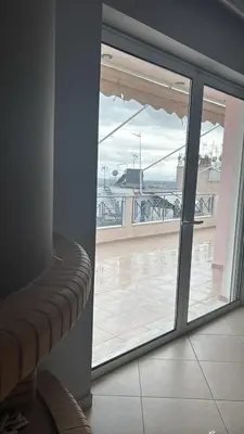 a room with a view of a balcony with a window at Spacious & Modern seaside house in Piraeus