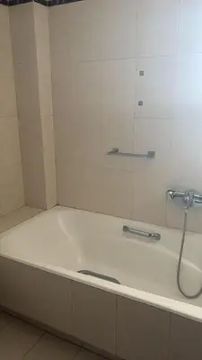 a bath tub in a bathroom with a shower at Spacious & Modern seaside house in Piraeus