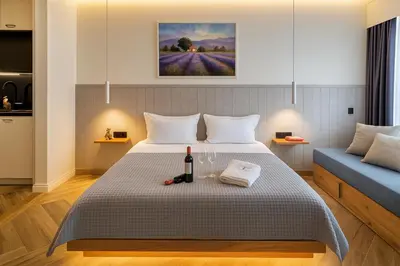 a bedroom with a bed with a bottle of wine on it at Triple A - Psiri Urban Magic Studios at Theatrou Square III Free Parking in Athens