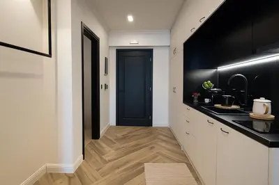 a hallway with a kitchen with a black door at Triple A - Psiri Urban Magic Studios at Theatrou Square III Free Parking in Athens