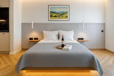 a bedroom with a bed with a bottle of wine on it at Triple A - Psiri Urban Magic Studios at Theatrou Square III Free Parking in Athens