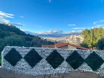 a crocheted blanket on top of a building at 20 mins from city centre, rural house in Athens