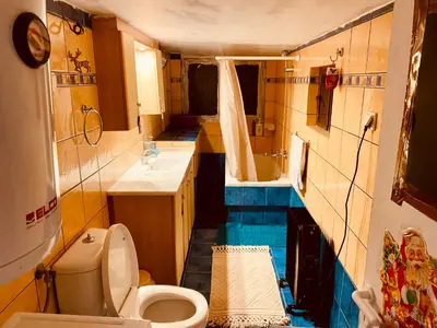 a small bathroom with a toilet and a sink at 20 mins from city centre, rural house in Athens