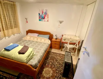 a small bedroom with a bed and a table at 20 mins from city centre, rural house in Athens