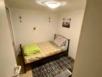 a small bedroom with a small bed in a room at 20 mins from city centre, rural house in Athens