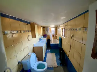 a bathroom with three sinks and a toilet and a tub at 20 mins from city centre, rural house in Athens