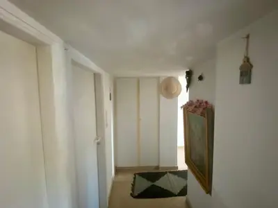 a hallway with white walls and a painting on the wall at 20 mins from city centre, rural house in Athens