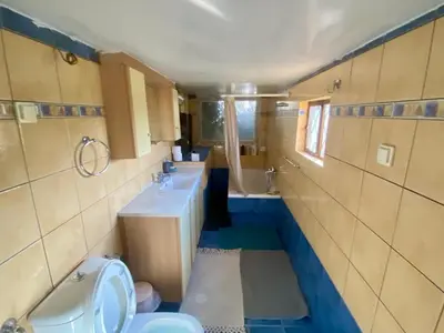 a bathroom with two sinks and a toilet and a tub at 20 mins from city centre, rural house in Athens
