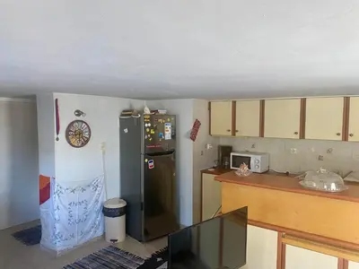a kitchen with a black refrigerator and a counter at 20 mins from city centre, rural house in Athens