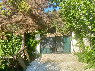 a gate to a house with a fence and trees at 20 mins from city centre, rural house in Athens